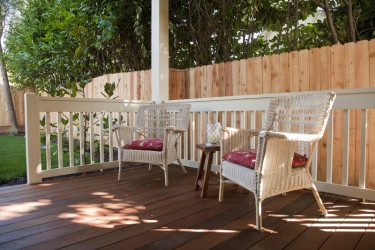 Patio furniture set on a deck in back yard.