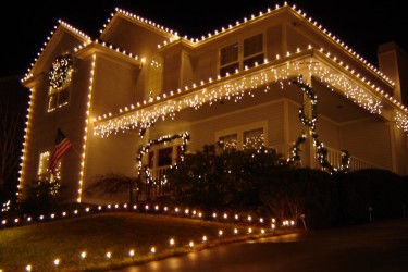 Street view of kansas city home with roof line christmas lights.